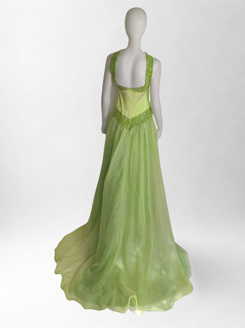 Green evening gown on a mannequin against a white background