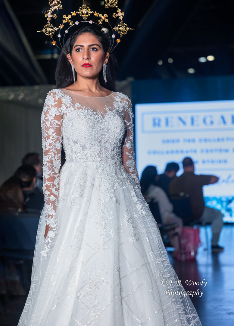Bride in custom lace wedding gown with gold halo crown, showcasing subversive bridal design at runway show