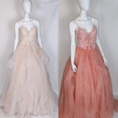Custom wedding dress in blush and coral, featuring lace bodice and tulle skirt for unique bridal style