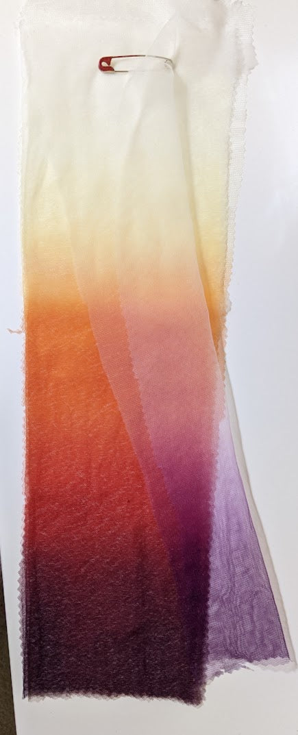 Ombre dyed fabric swatches in warm sunset hues, showcasing custom bridal dyeing for wedding dresses.