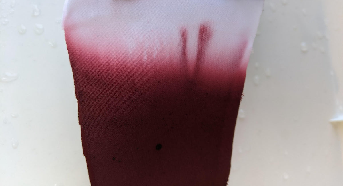 Deep burgundy ombre dye effect on wedding dress fabric, showcasing custom color gradient for bridal gowns