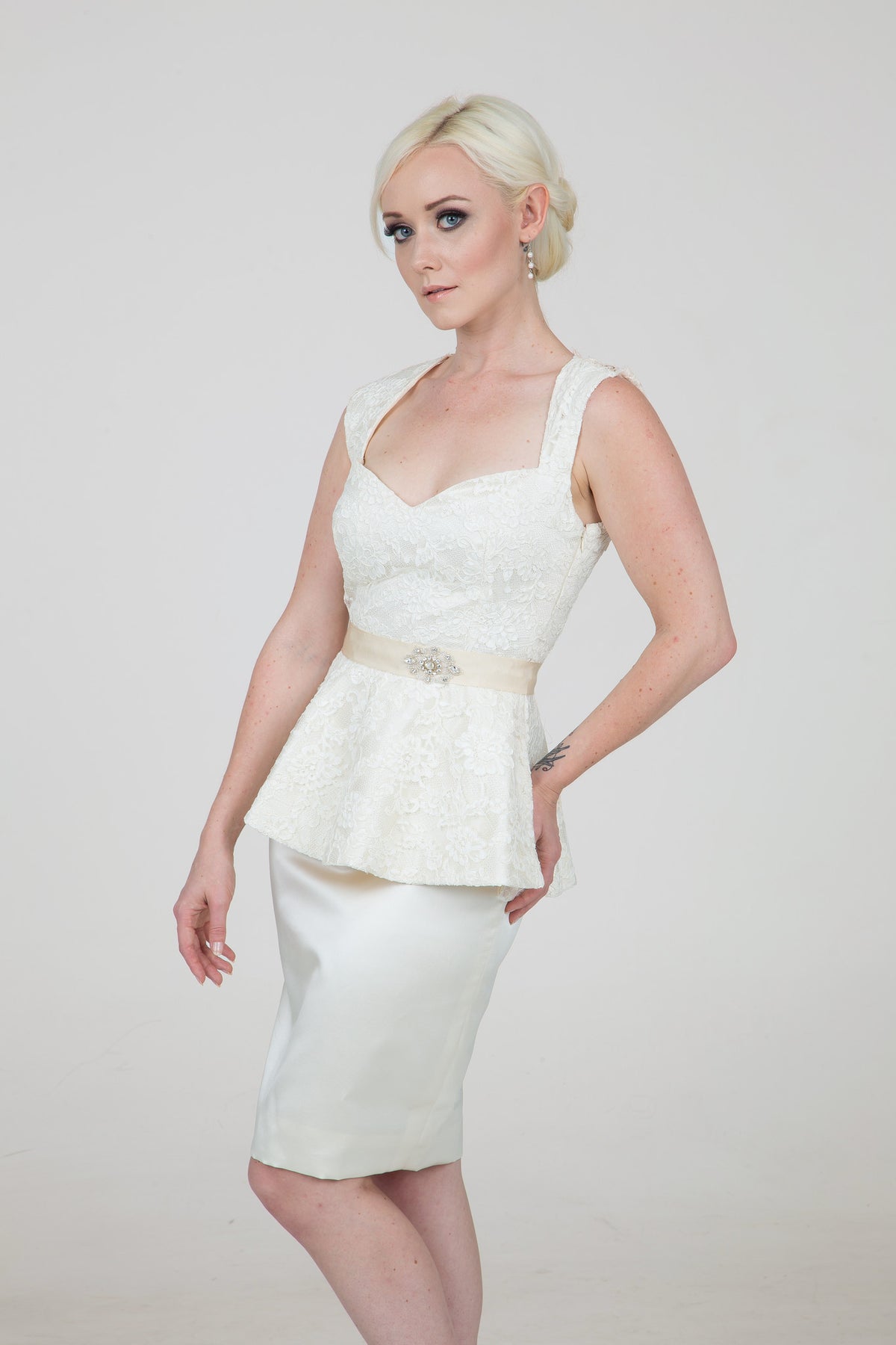 Elegant lace peplum top with satin skirt, perfect for custom bridal or semi-formal celebrations.