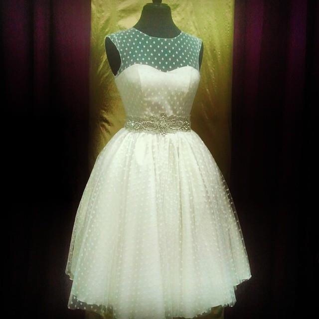 Short polka dot wedding dress with teal bodice, tulle skirt, and beaded belt for custom bridal style