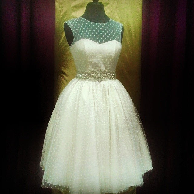 Custom white polka dot wedding dress with teal bodice and beaded belt, perfect for unique bridal style.
