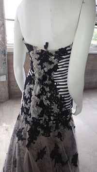Black lace wedding dress with striped bodice on mannequin, custom bridal design