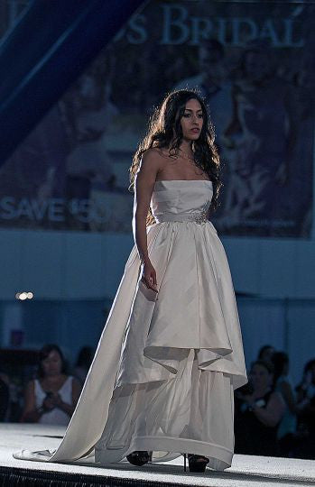 Bridal gown with layered skirt and strapless design on runway