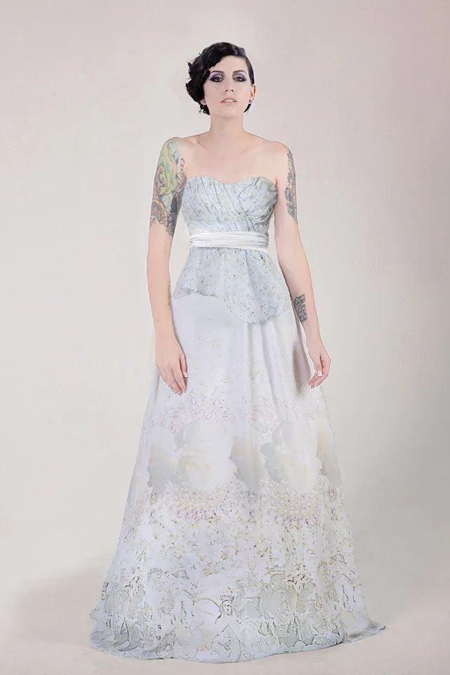 Strapless floral wedding gown with peplum waist, ombre floral print, and tattooed bride