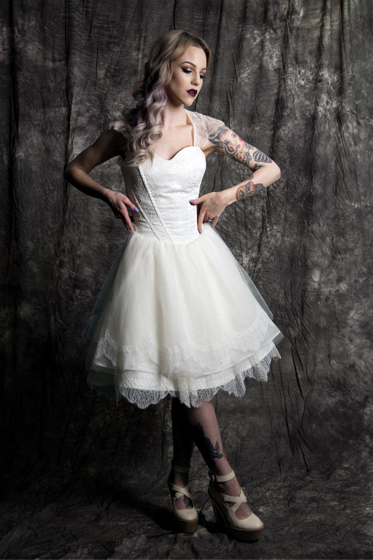 Tattooed bride in short lace wedding dress with corset bodice, edgy bridal style for alternative weddings