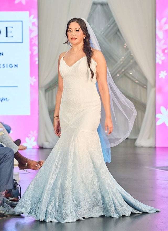 Mermaid wedding dress with ombre blue lace, veil, and V-neckline on runway