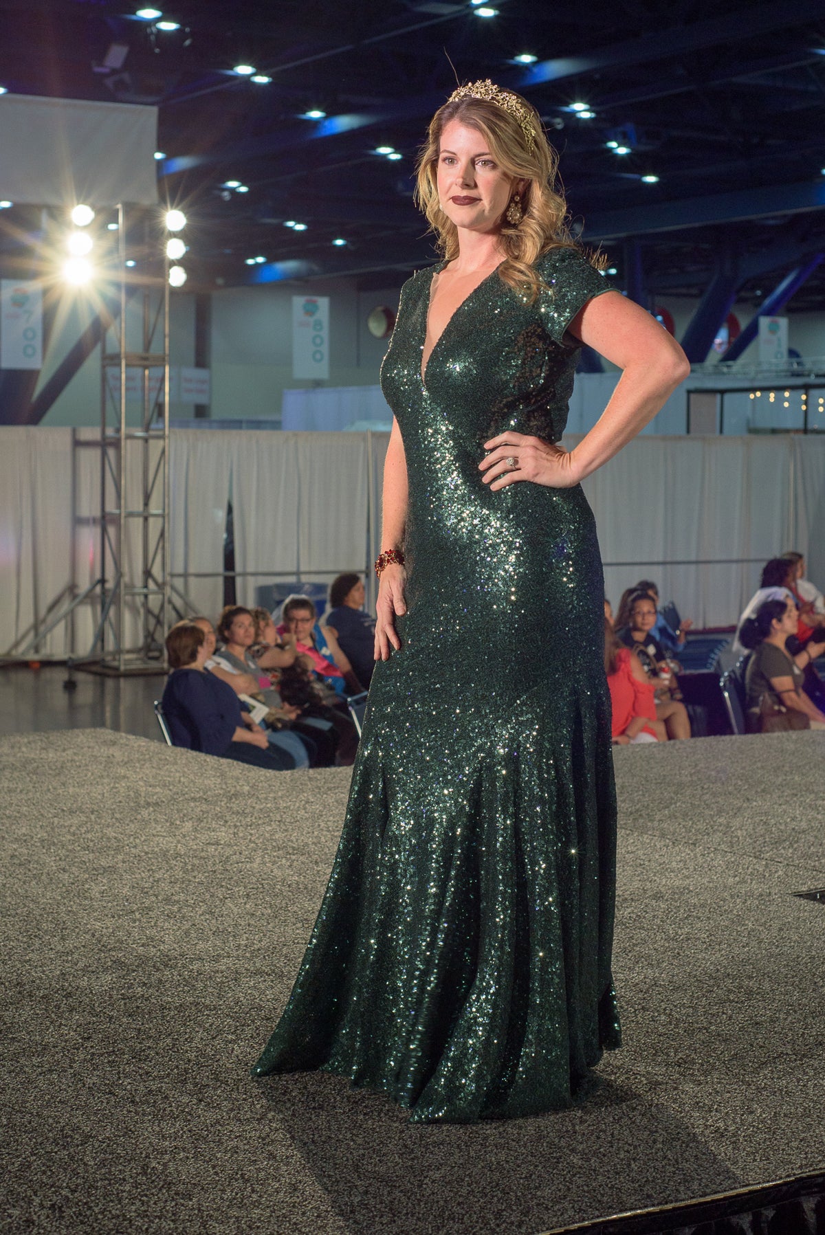 Emerald green sequin wedding gown on runway, custom bridal design with V-neck and cap sleeves