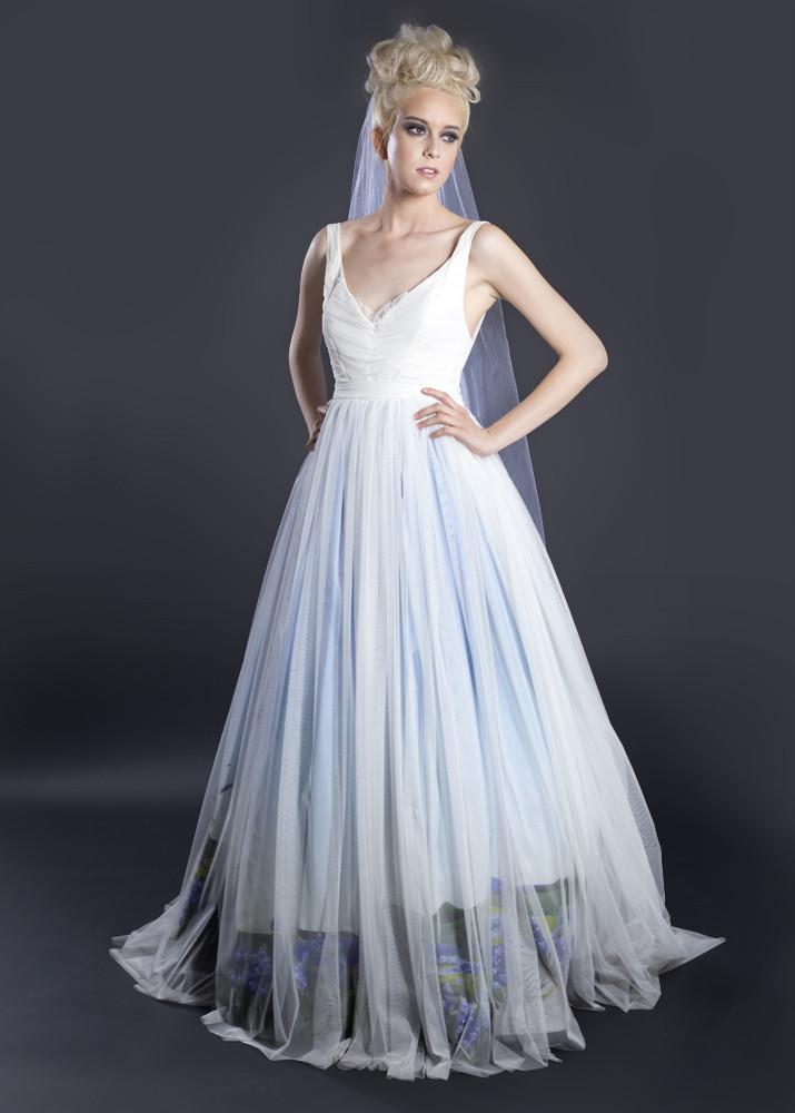 Custom ombre wedding dress with blue gradient tulle skirt and floral hem, styled with veil for modern bridal look