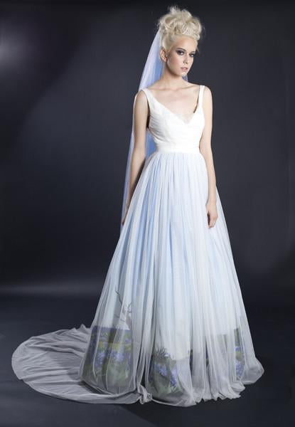 Custom wedding dress with ombre dye effect, sheer tulle skirt, and blue veil for inclusive bridal style