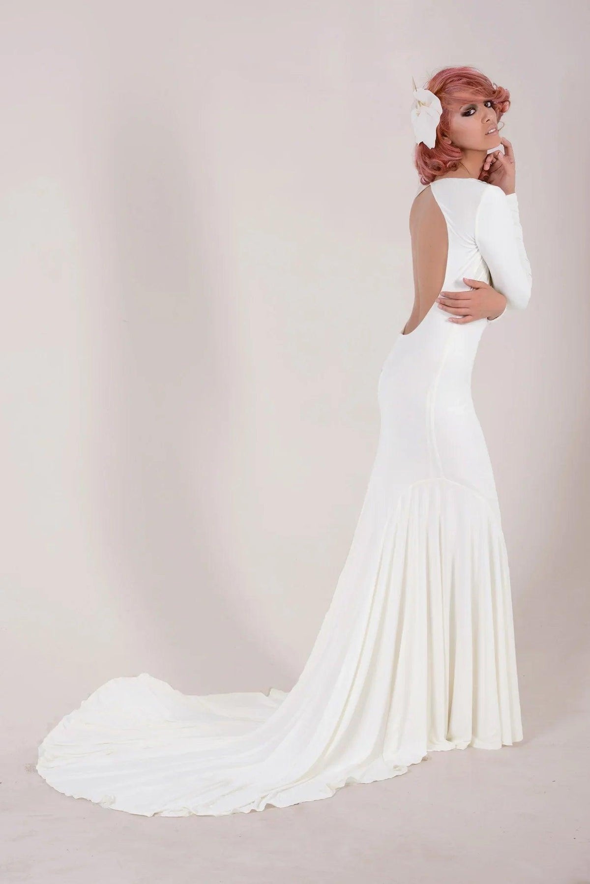 White mermaid wedding dress with long train, back cutout, and long sleeves for custom bridal style