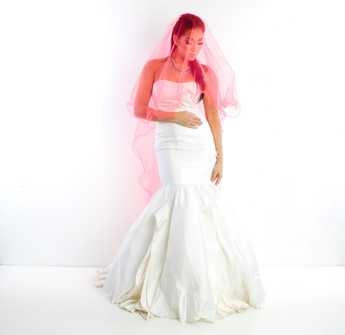 Bride in white mermaid gown with pink veil, elegant wedding dress for modern celebrations