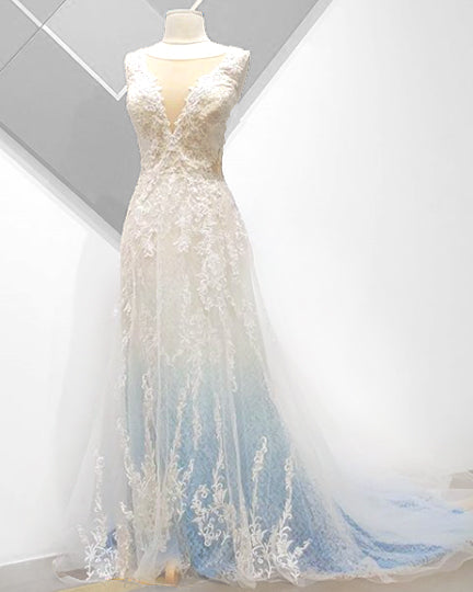 Custom ombre wedding dress with lace detailing, transitioning from white to soft blue, perfect for inclusive bridal celebrations.