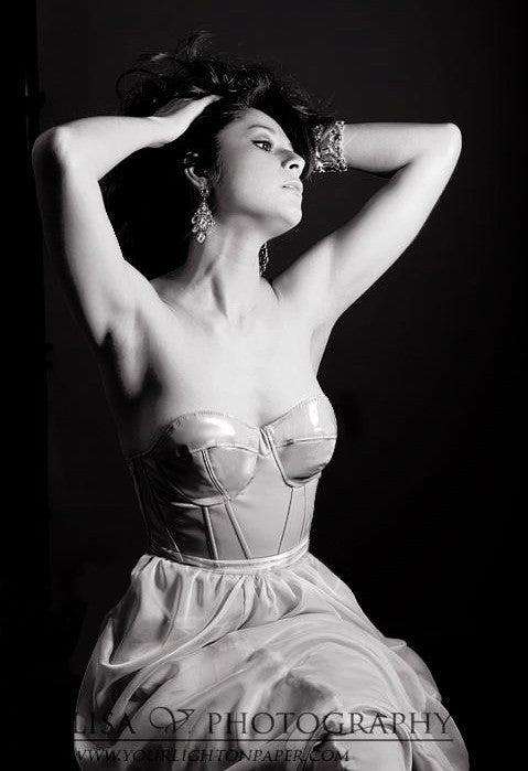 Elegant strapless wedding dress with corset bodice and flowing skirt, styled for bridal photoshoot