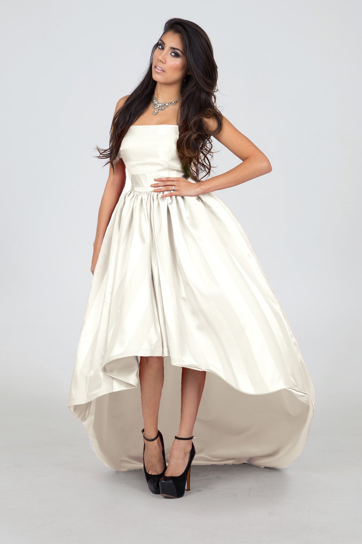 Elegant ivory high-low wedding dress with strapless design and flowing skirt