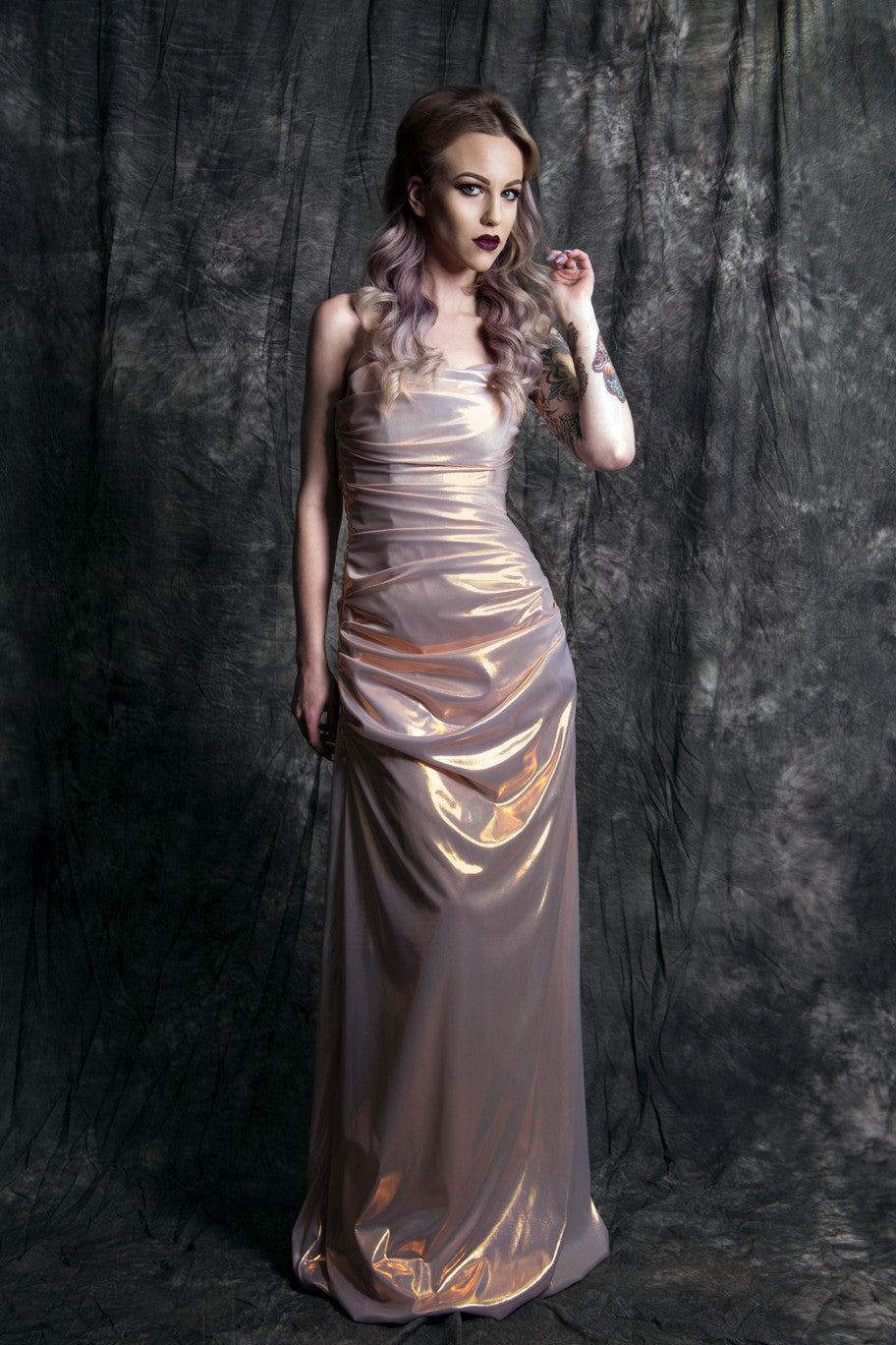 Shimmering rose gold wedding dress with ruched detailing, perfect for modern bridal elegance.