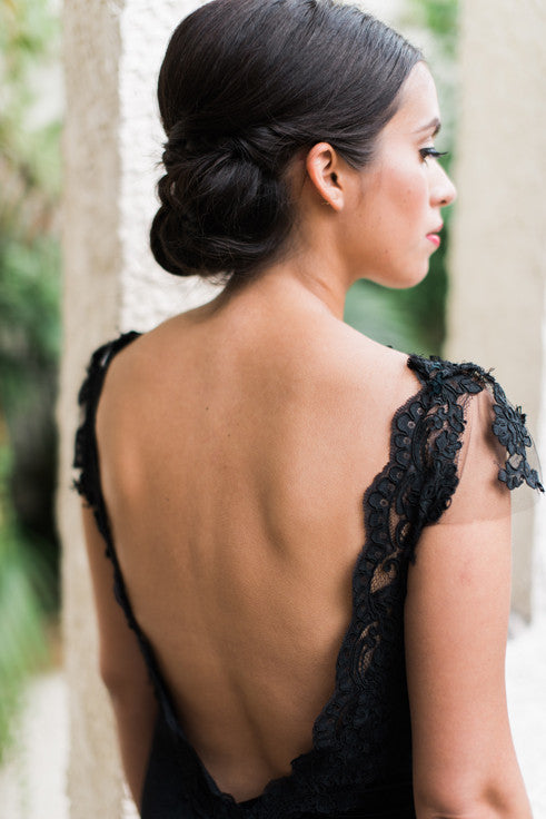 Black lace wedding dress with open back and intricate detailing, perfect for bold bridal styles.